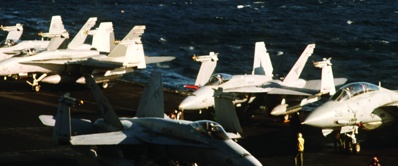 F/A-18 Hornet and F-14 Tomcat fighter jets from Captain Speicher's squadron parked on the flight deck of the USS Saratoga at sea.